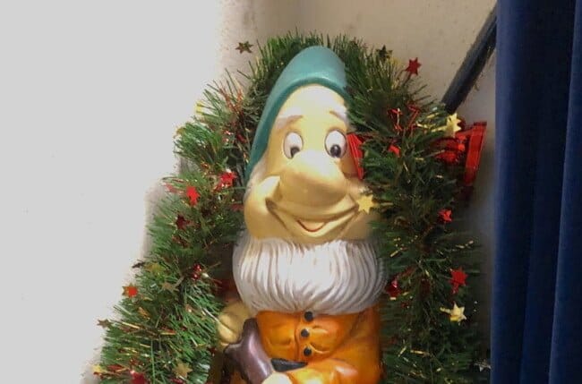 Ornamental gnome festooned with tinsel