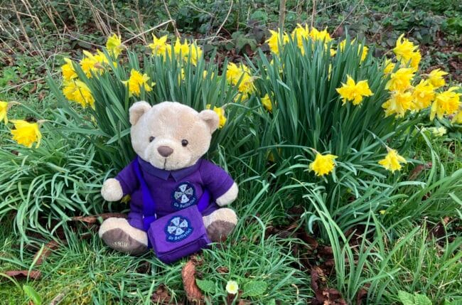 Bertie the mascot with daffodils