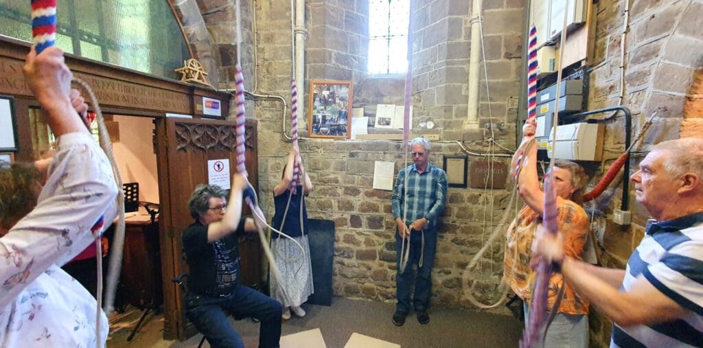 A group of ringers in the ground floor ringing chamber ringing before the AGM