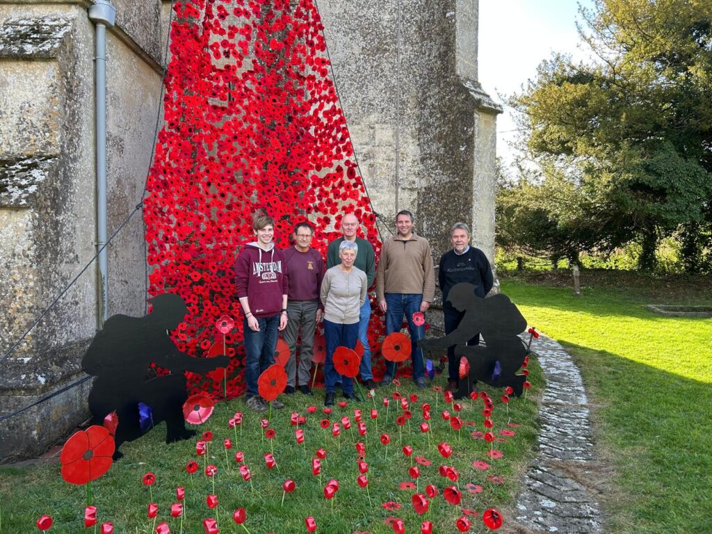 Ringers outside the tower festooned with remembrance poppies