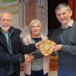 Evershot Tower Captain, Gareth Evans, being presented with the Striking Competition Shield by Judges, Sue Carter and Jonathan Godfrey